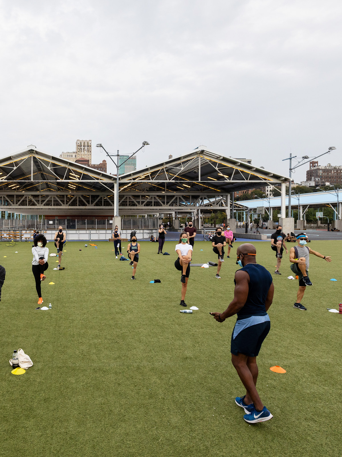 Group standing and stretching on Pier 2 Play Turf.