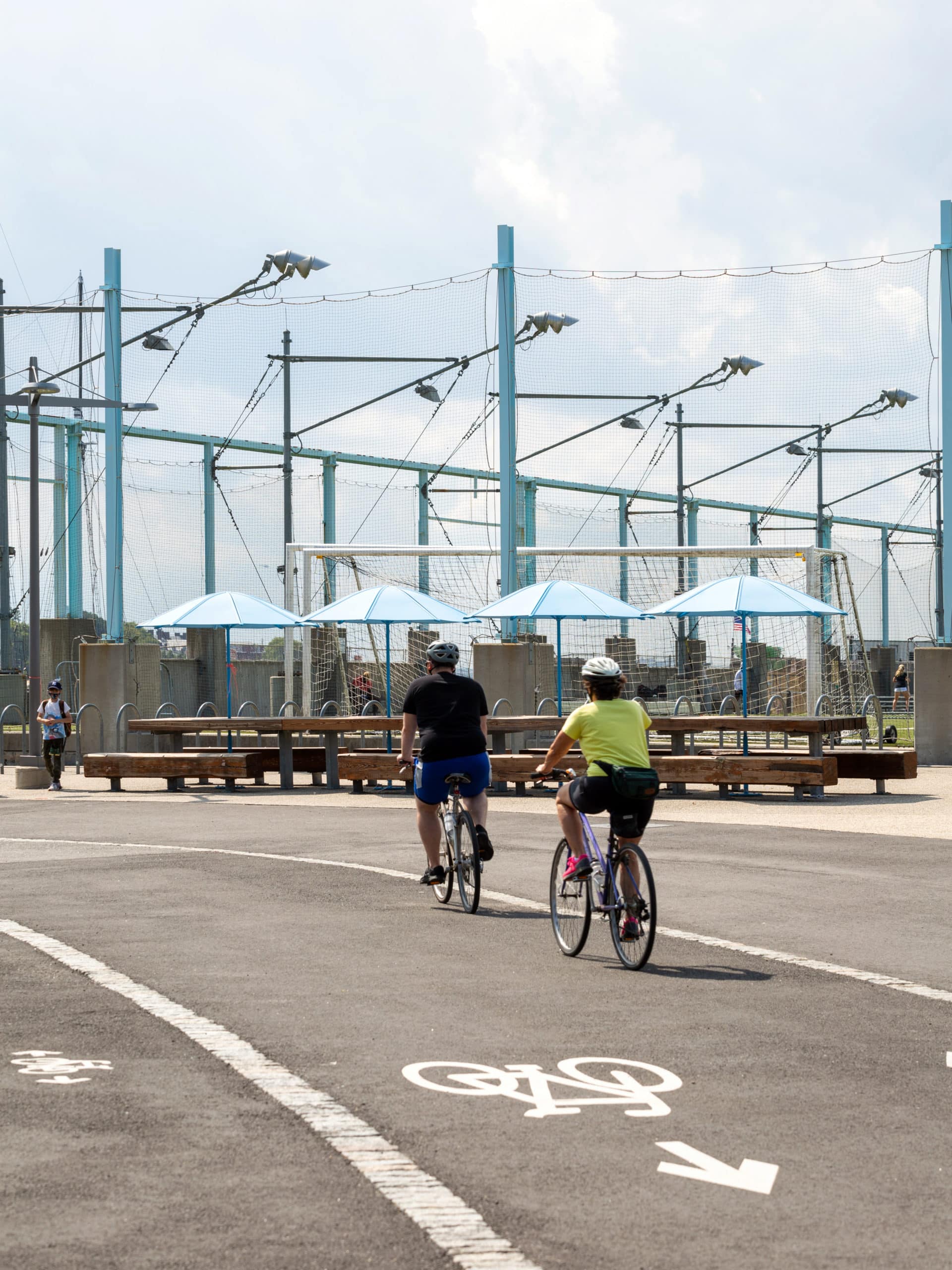 Bikers riding by Pier 5 on a sunny day.