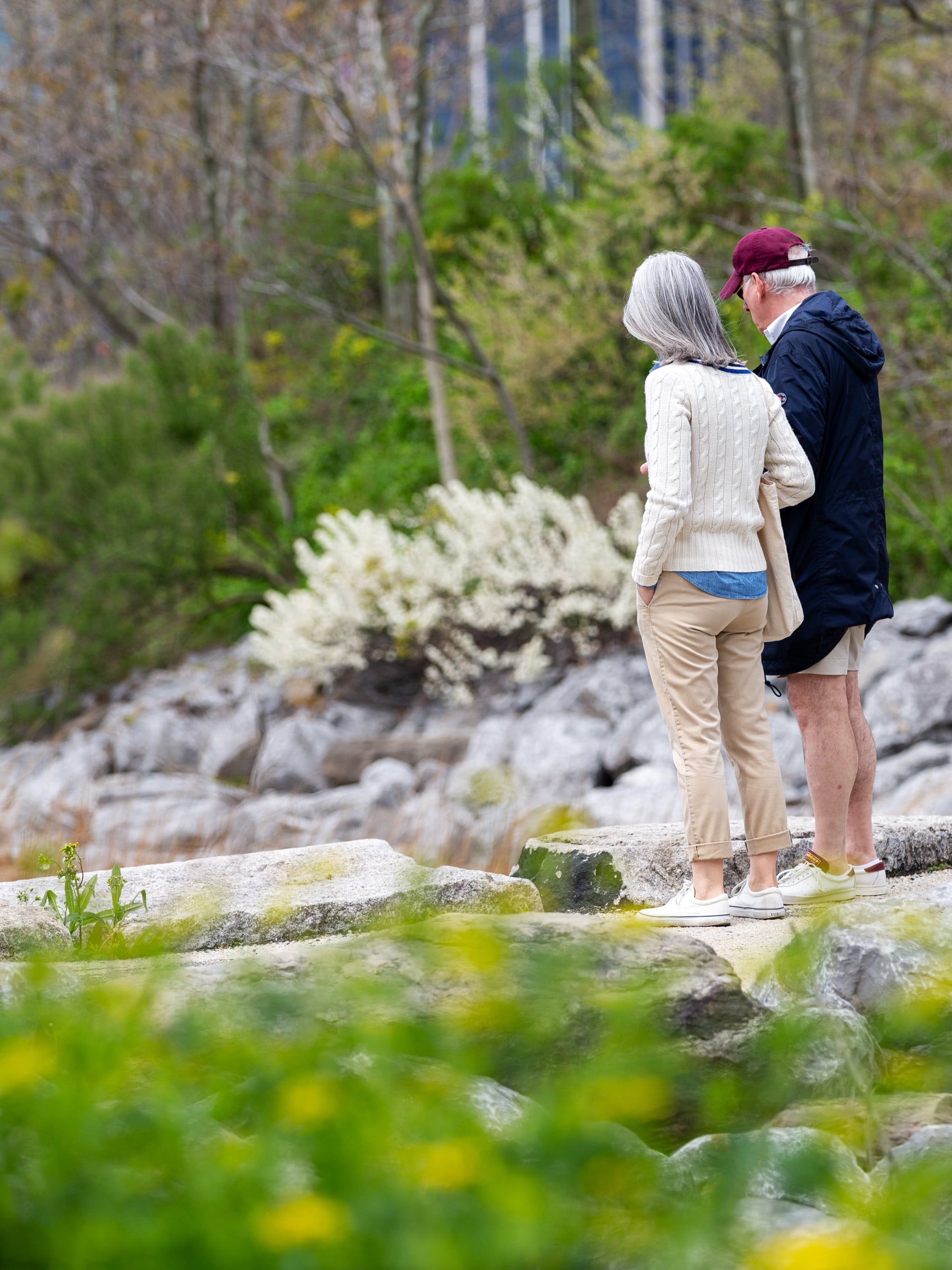 Couple standing on the pathway looking at the Greenway on a cloudy day.