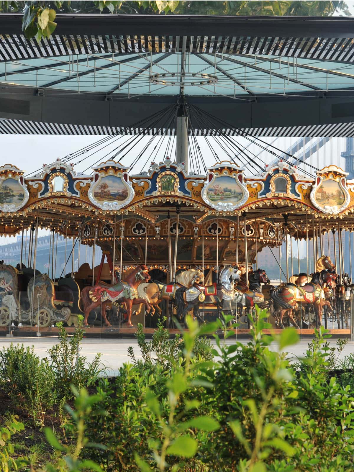 View of Jane's Carousel from pathway underneath a glass roof.