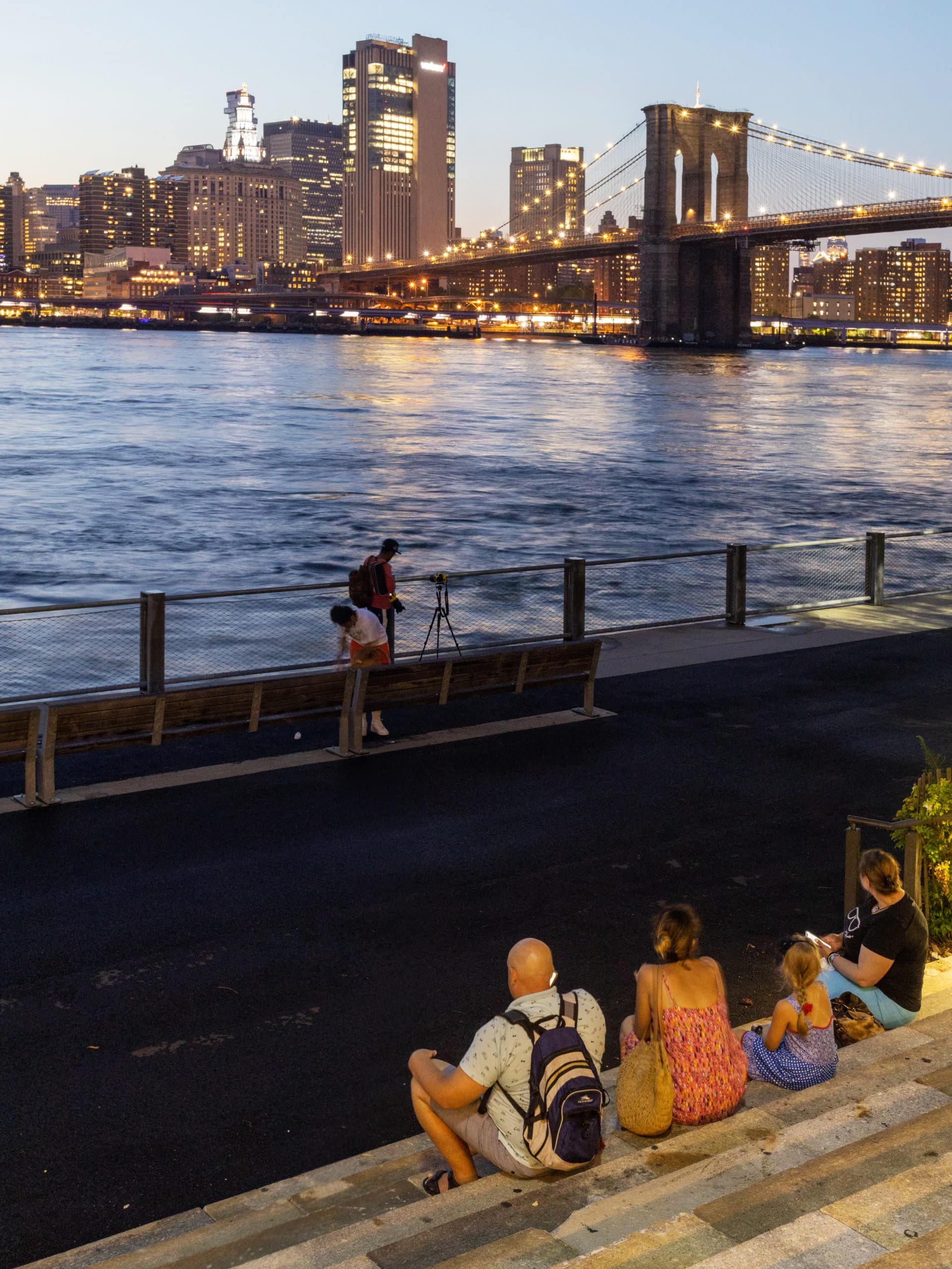 View from the Granite Prospect steps of the Brooklyn Bridge and lower Manhattan at night.