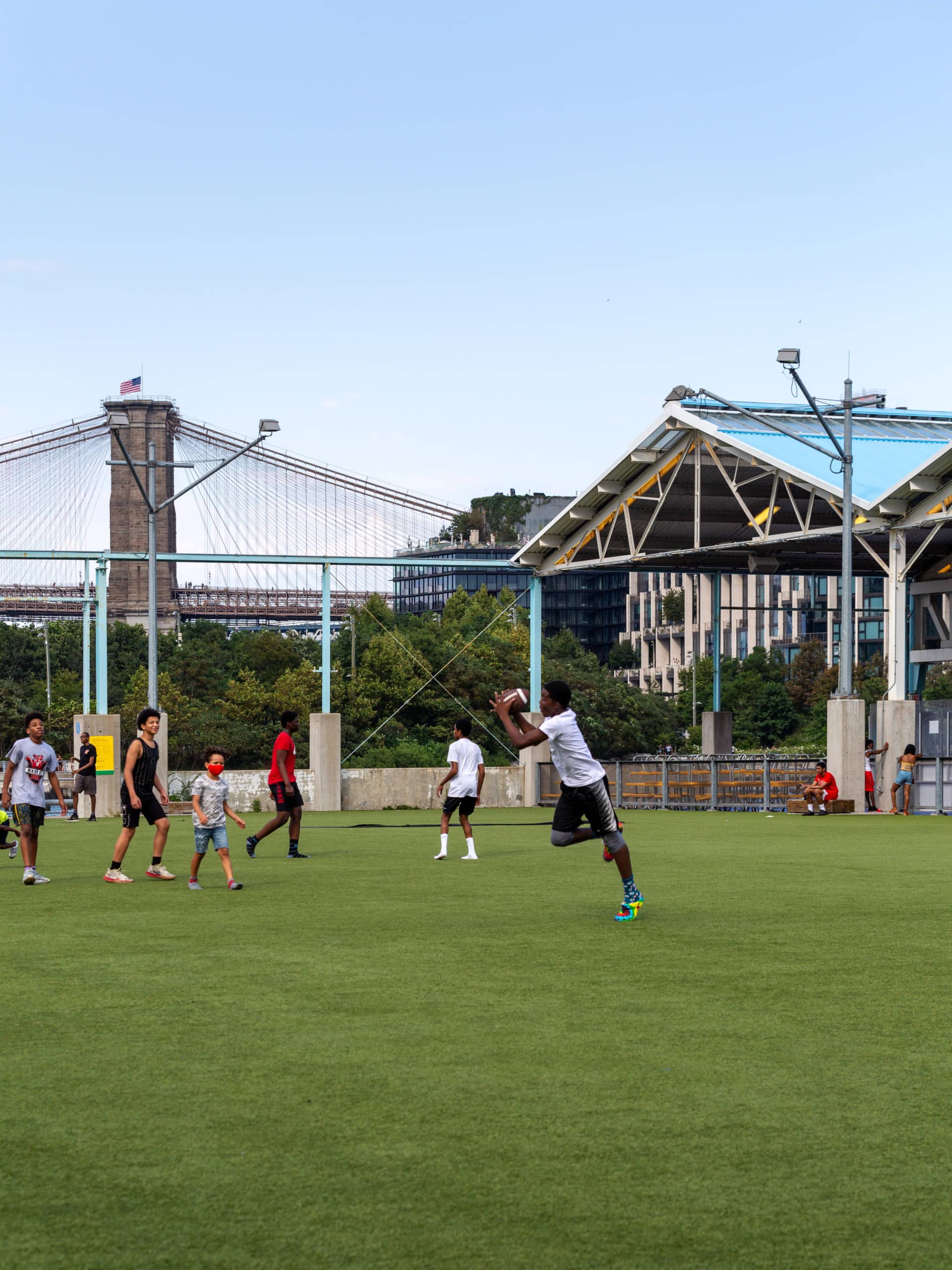 Boys playing football on the Play Turf on a cloudy day.