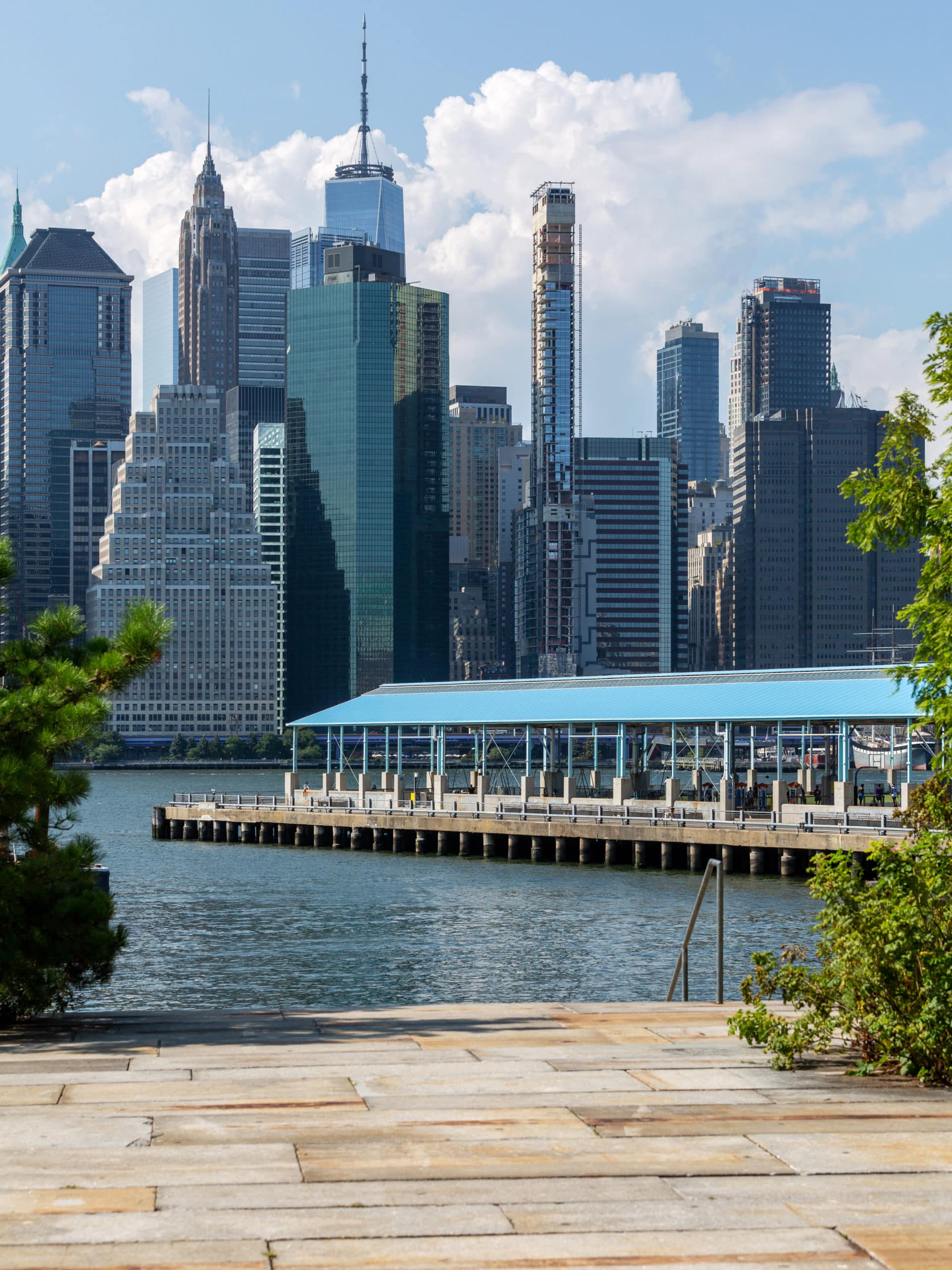 Stone terrace overlooking the water and Pier 2 on sunny day.