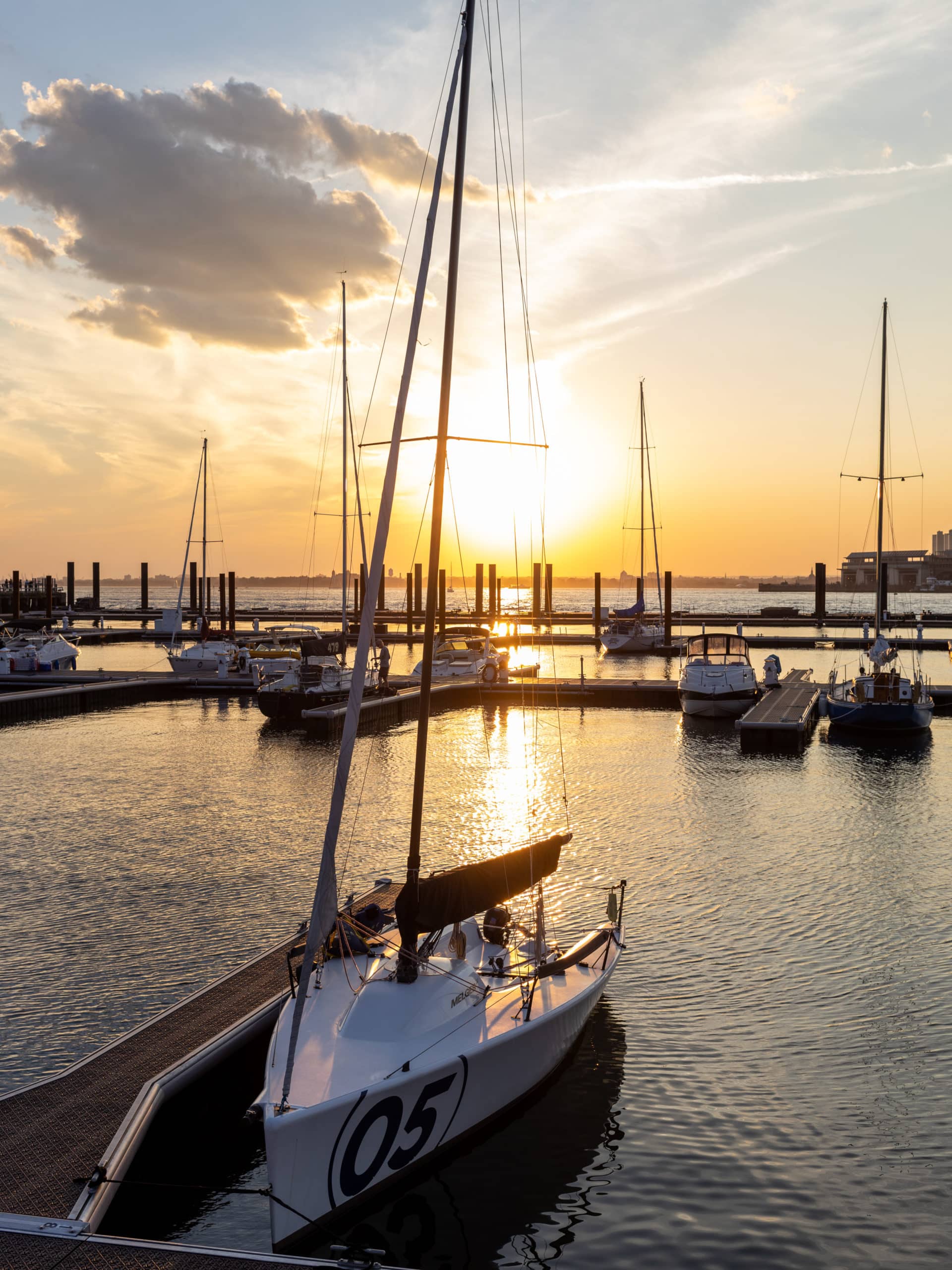 Docked sailboat at ONE°15 Brooklyn Marina at sunset.