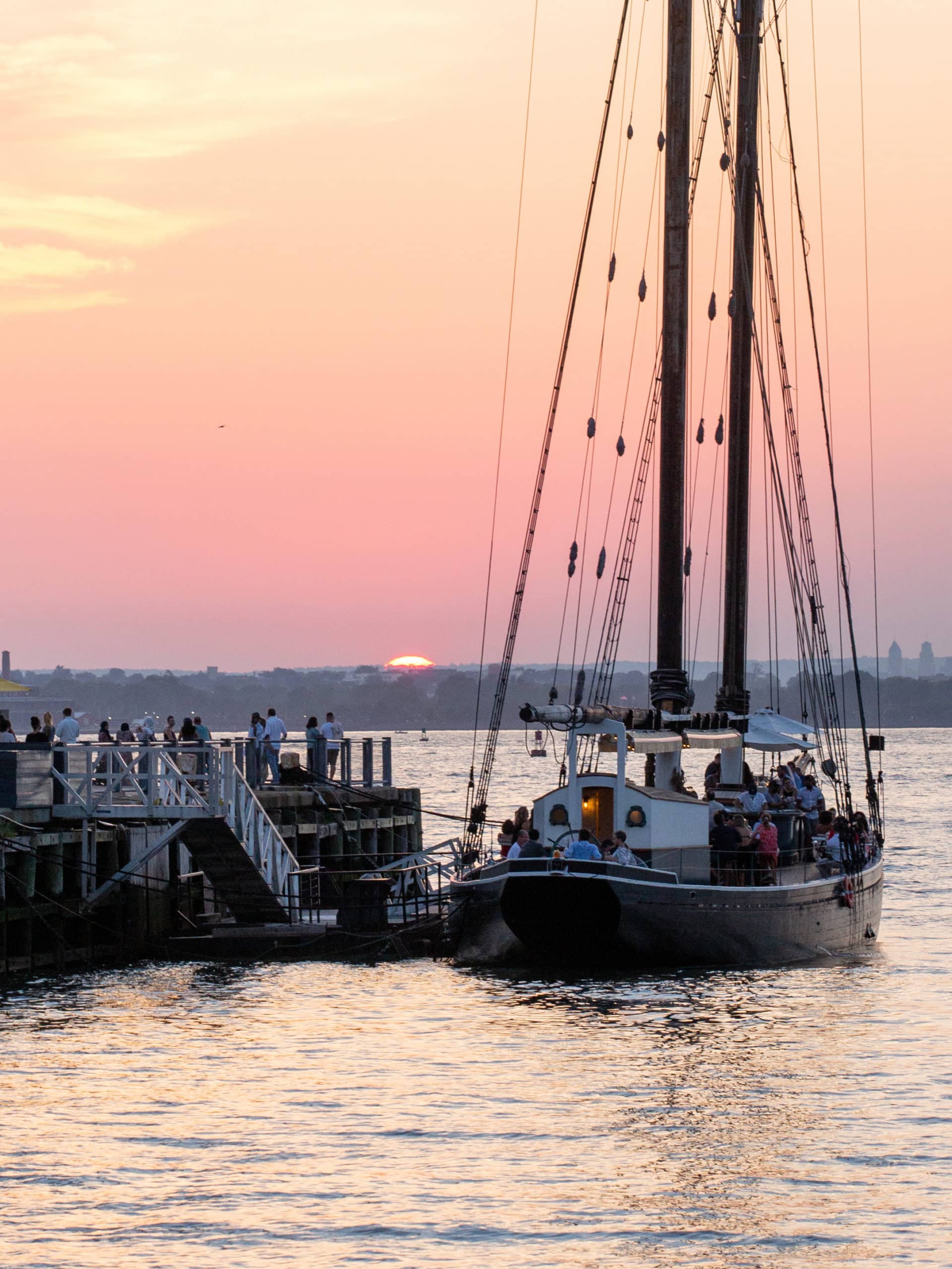 People dining on the historic boat Pilot at sunset.