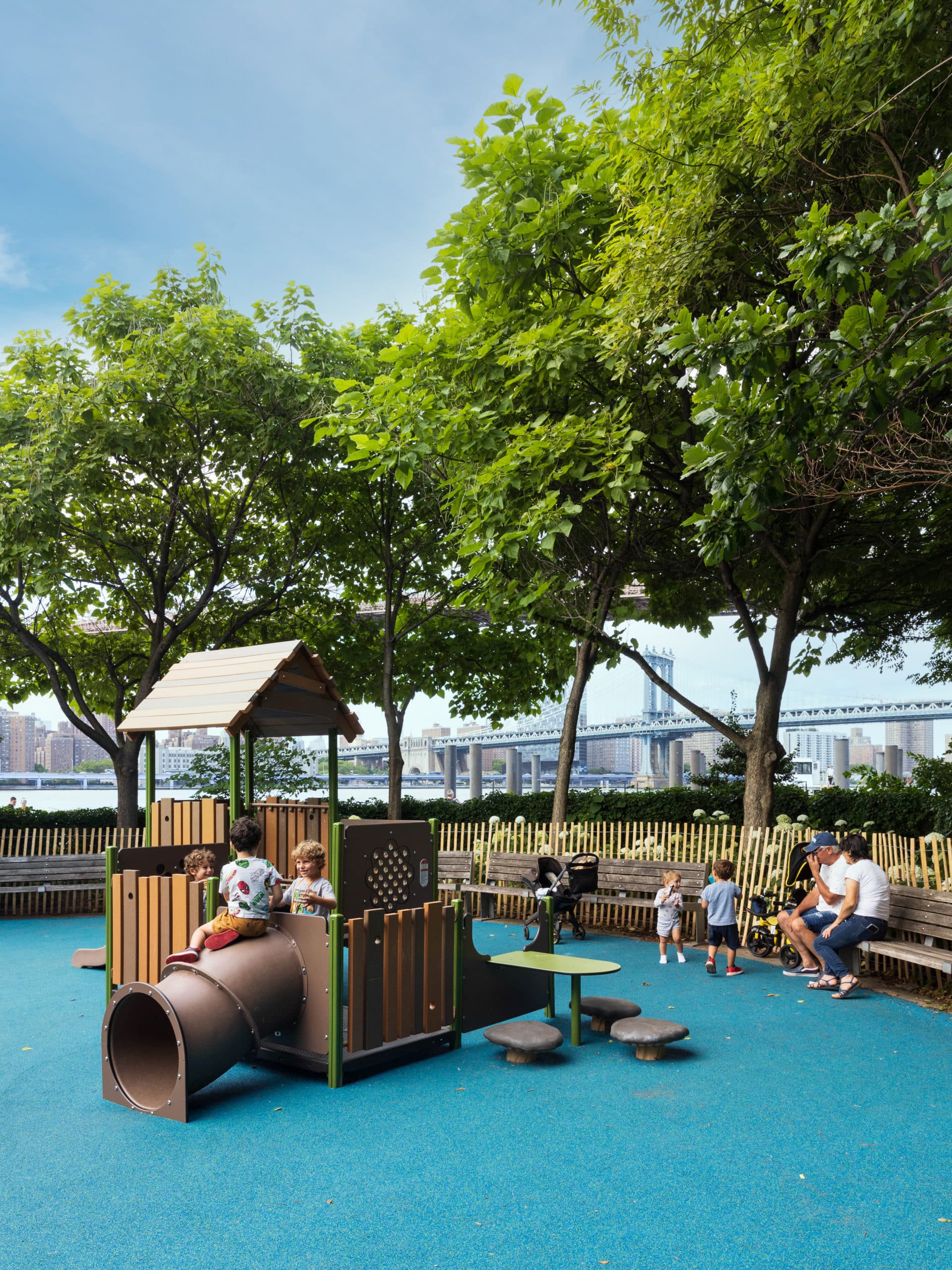 Children play in the shadow of bridges at Pier 1 Playground