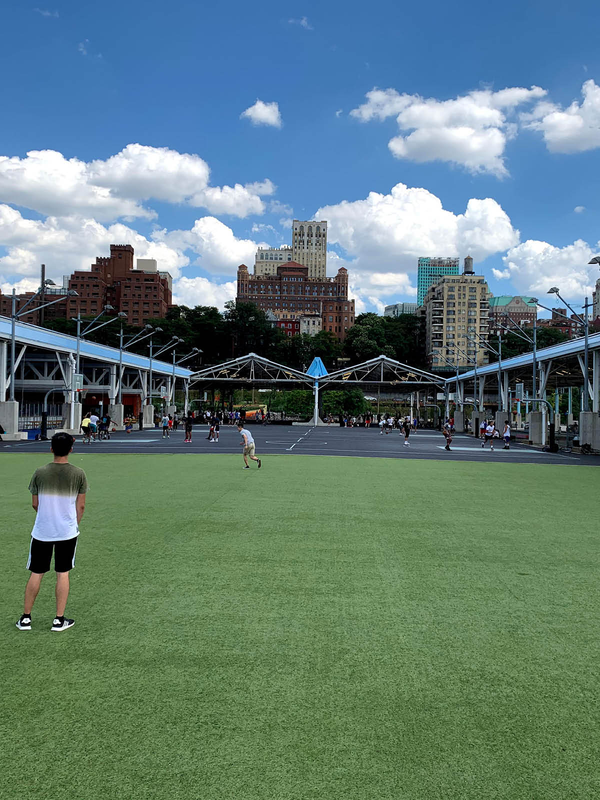 Pier 2 Play Turf with a view of the basketball courts on a cloudy day.