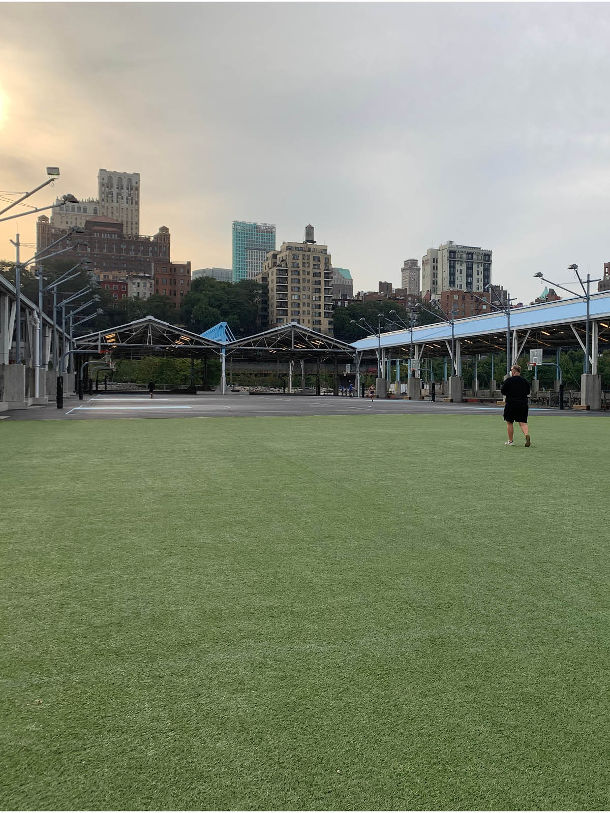 Pier 2 Play Turf with a view of the basketball courts on a cloudy day.