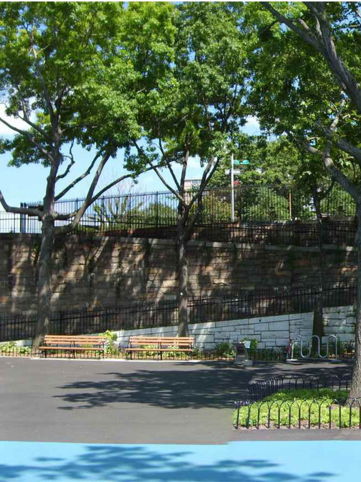 Benches and entrance ramp in Squibb Bridge Park on a sunny day.