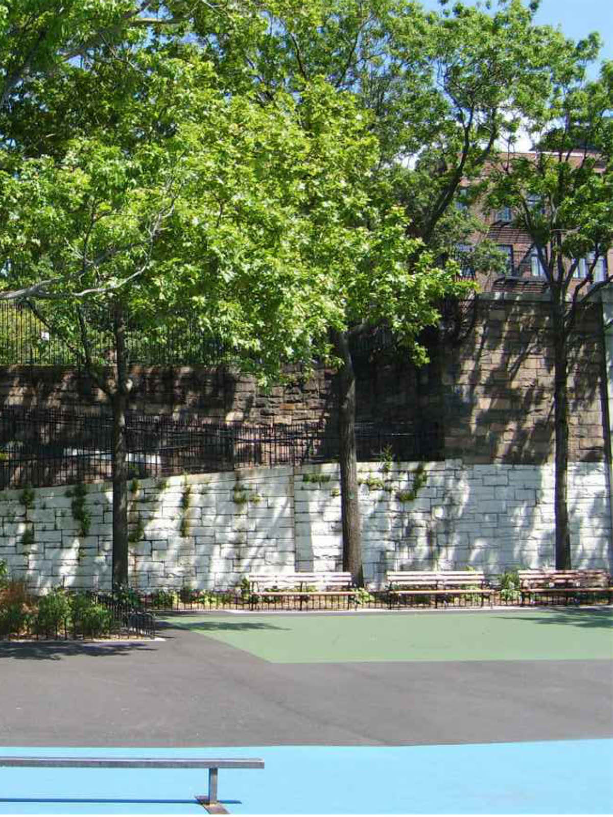 Benches in Squibb Bridge Park on a sunny day.