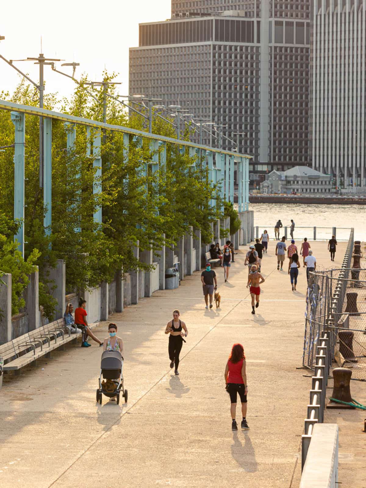 People running along the Pier 3 Promenade at sunset.