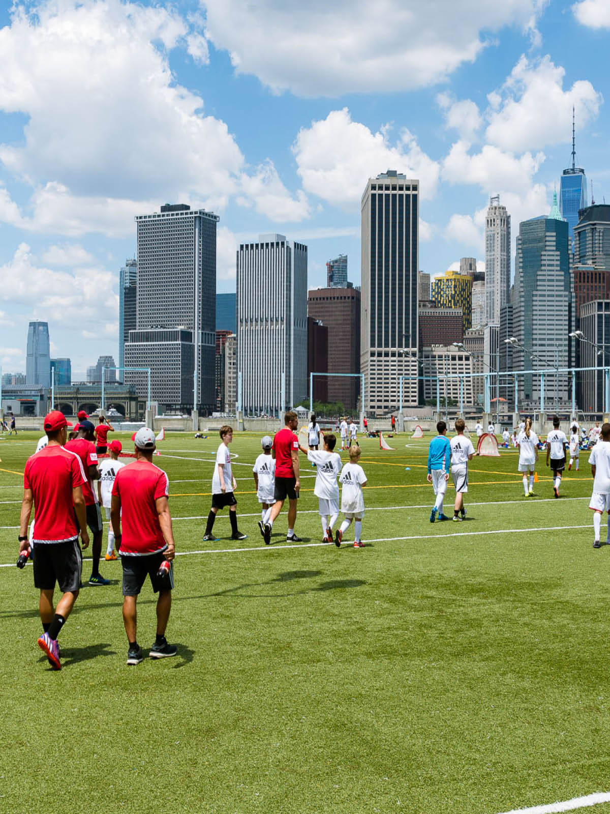 Players walking on to the field on a sunny day.