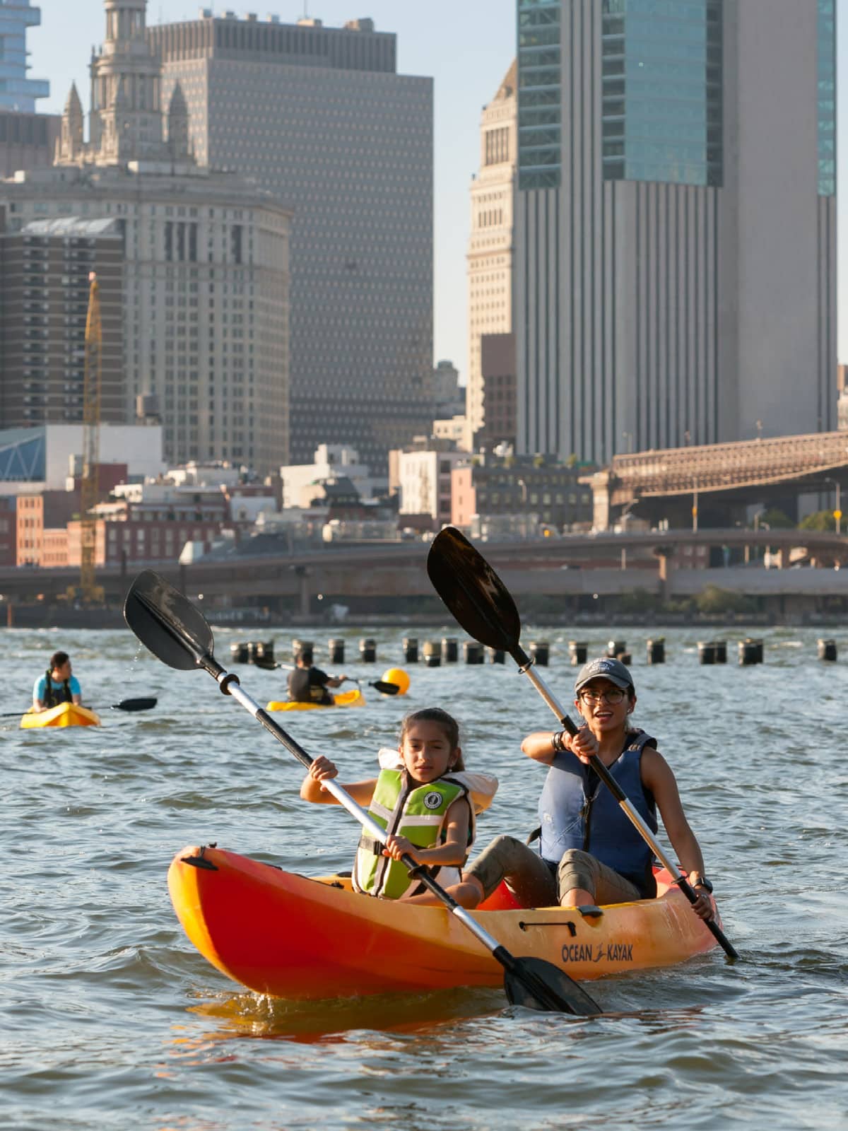 Close up of two girls in a kayak at sunset.