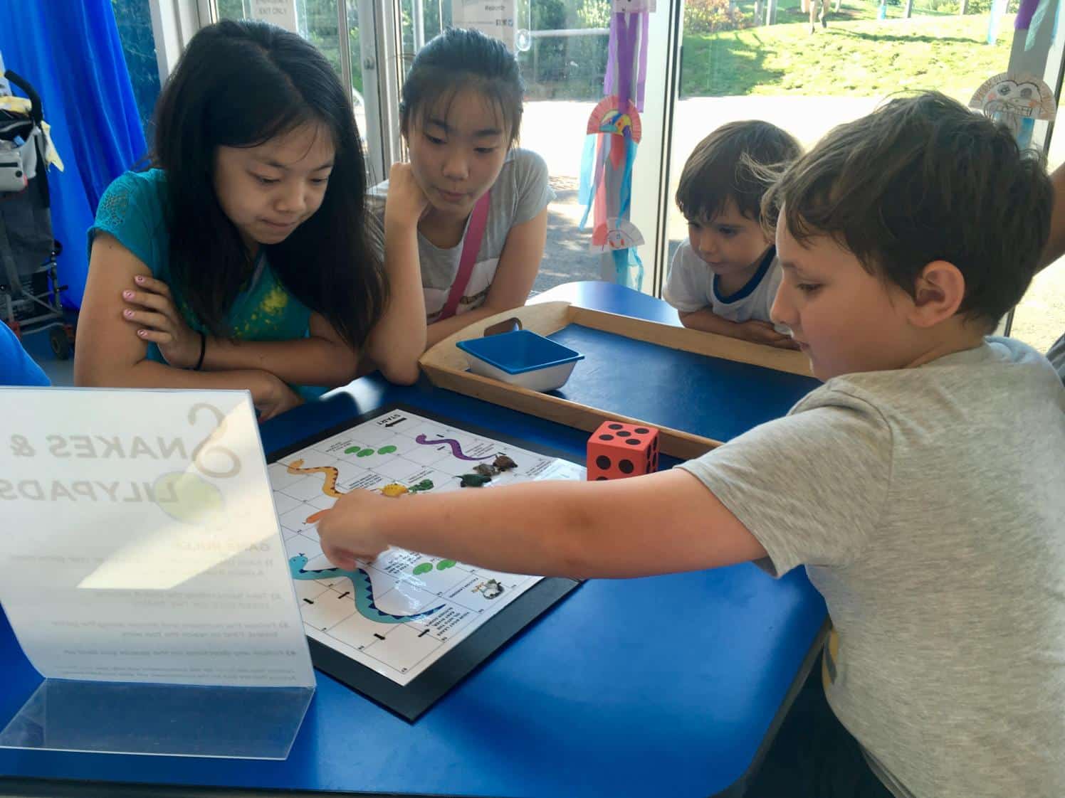 Children playing reptile game in a classroom.