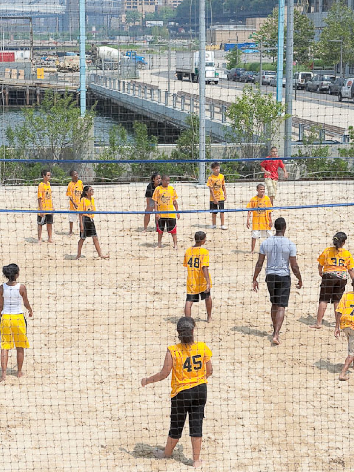 Aerial view of children's volleyball game on a sunny day.